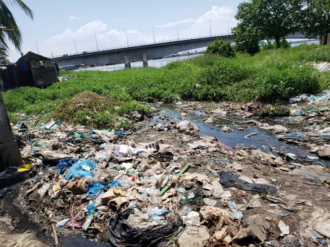 Figure 5. Dumping of solid waste materials under the bridge, river in the center of Monrovia city